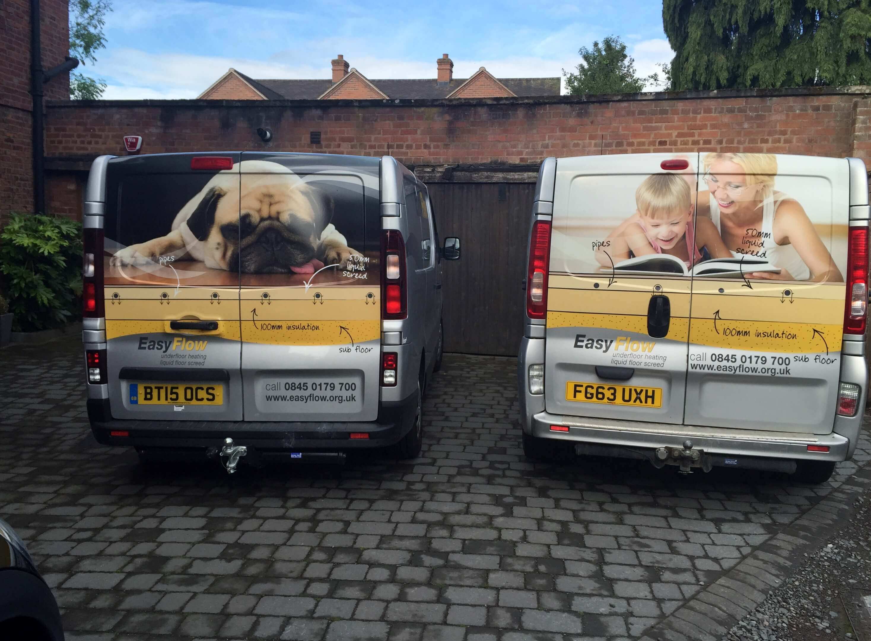 Two vans parked at a home where underfloor heating for wooden flooring is being installed