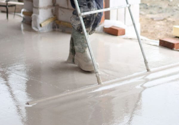 Underfloor heating Manchester installer smoothing the screed