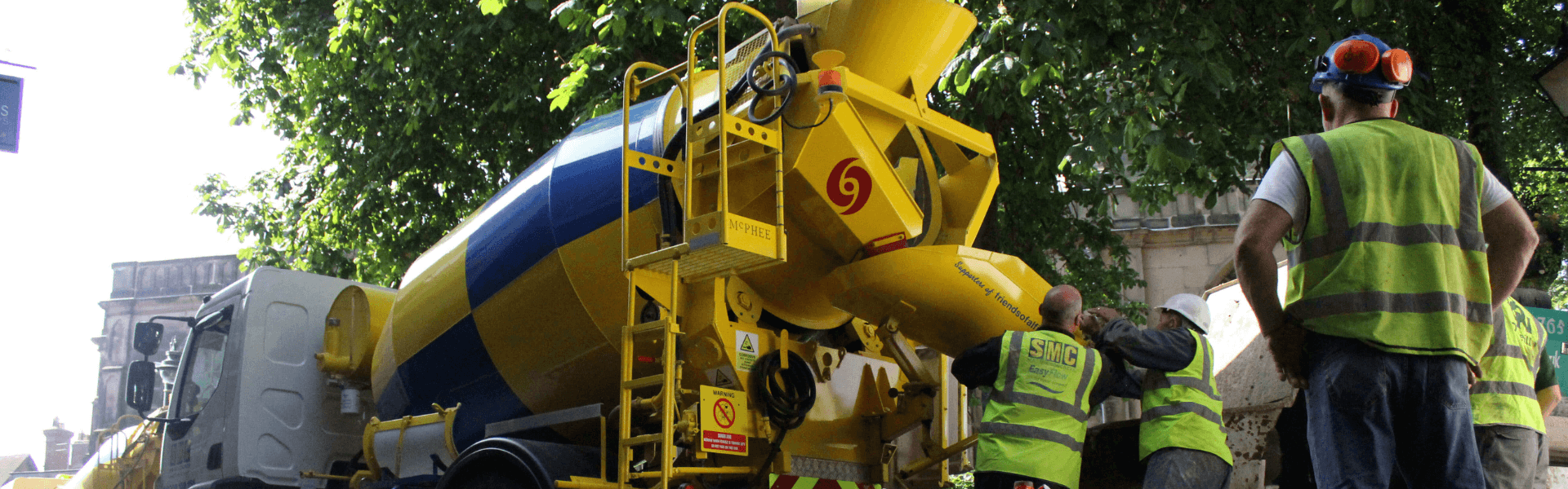 Floor screeding professionals preparing a mixer machine