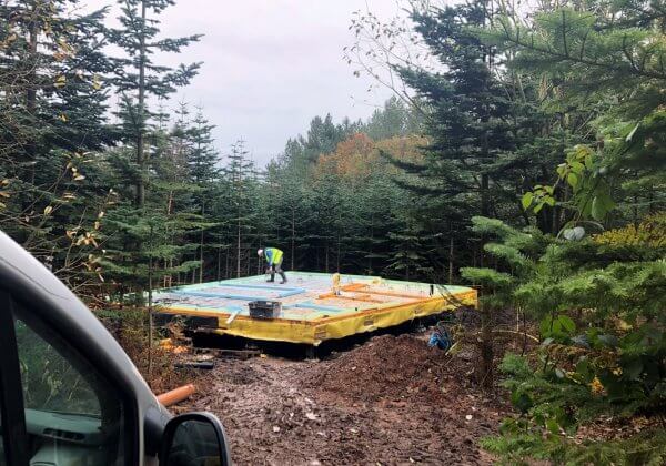 Self compacting concrete laid over underfloor heating in a forest holiday lodge