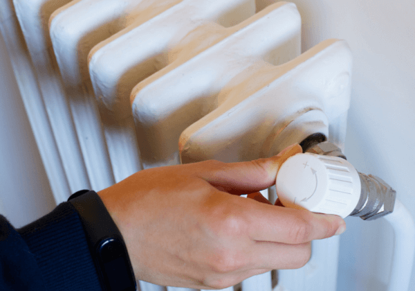 Underfloor heating installer checking a radiator