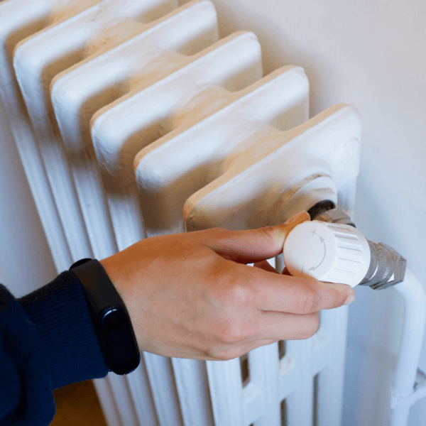 Underfloor heating installer checking a radiator