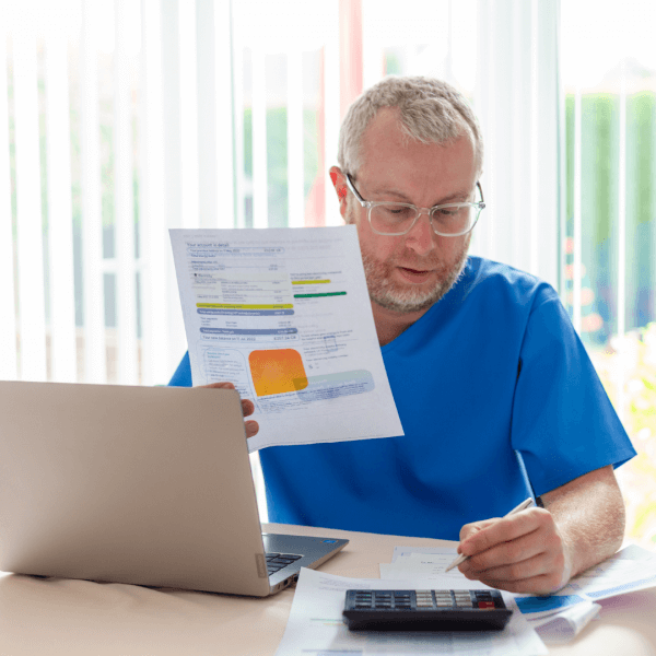 A man calculating the savings he earned from energy efficient heating