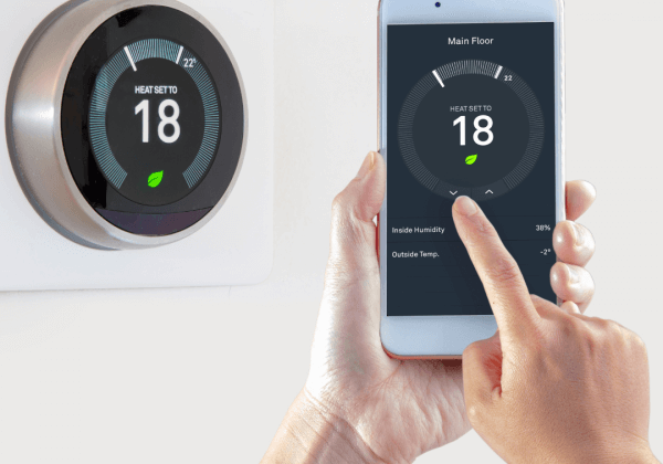 a smart underfloor heating thermostat being controlled by a mobile phone app