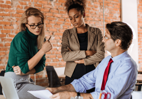 Three workers discussing energy efficiency in the workplace