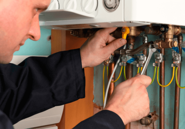 A boiler being removed, soon to be replaced by a heat pump