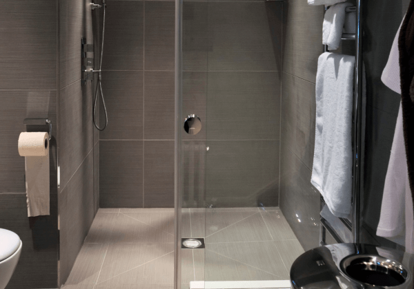 a wet room with walk in shower and underfloor heating installed