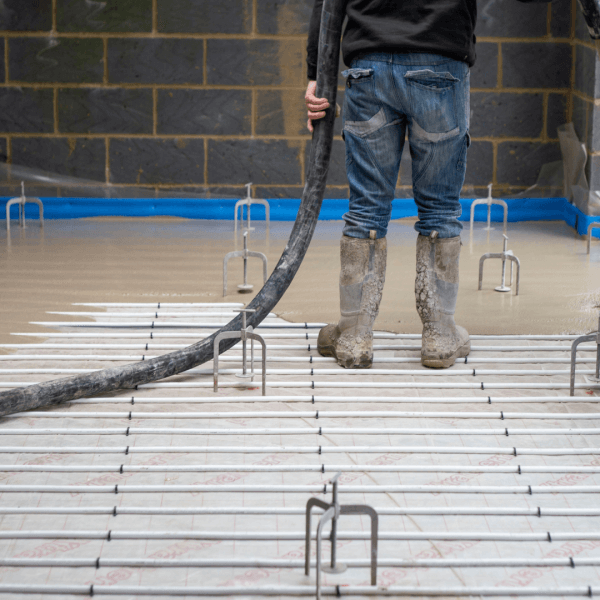 Image of liquid screed being pumped into home renovation project.