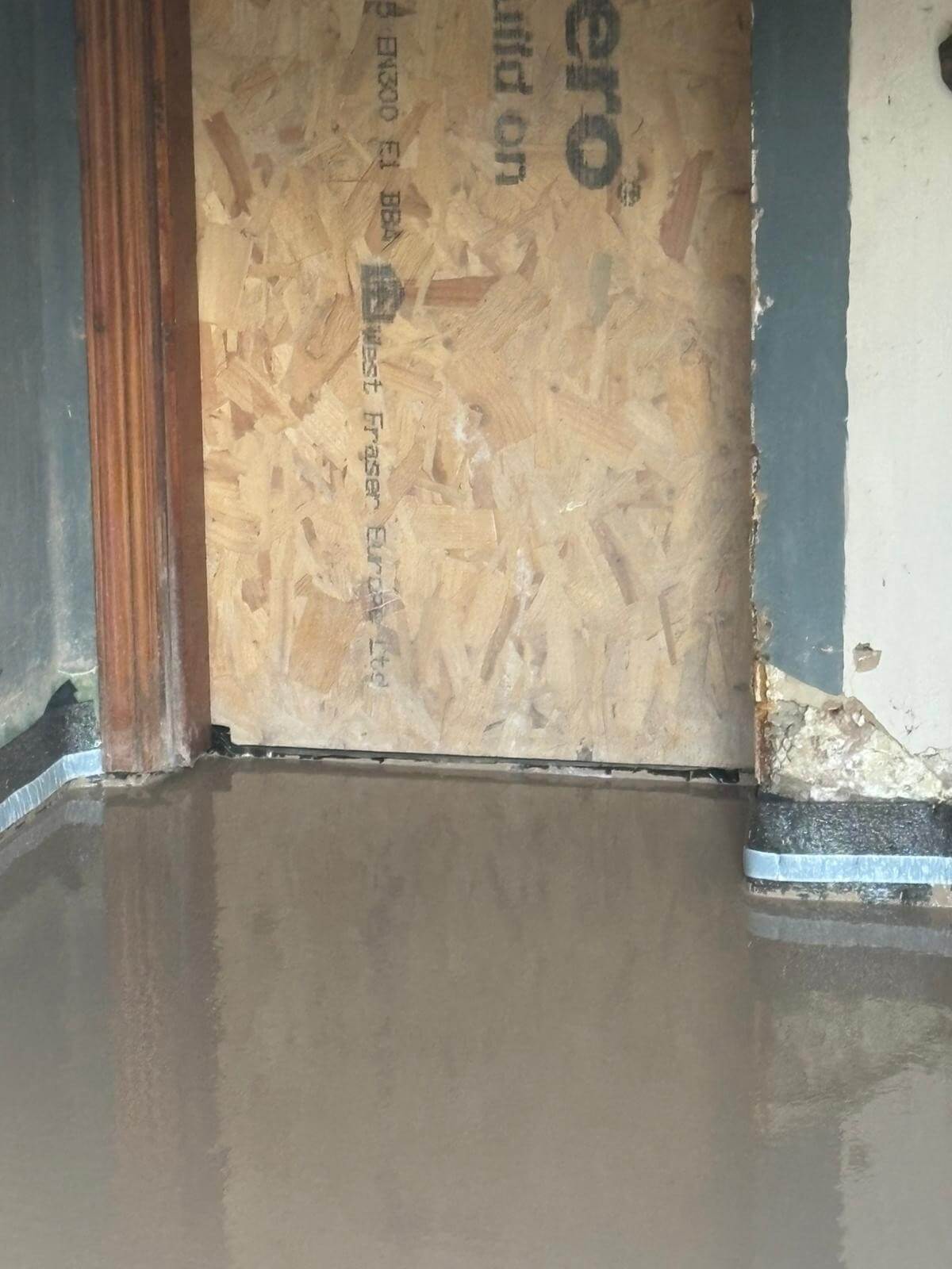Underfloor heating pipes being installed over the prepared Excelio screed floor in a residential renovation