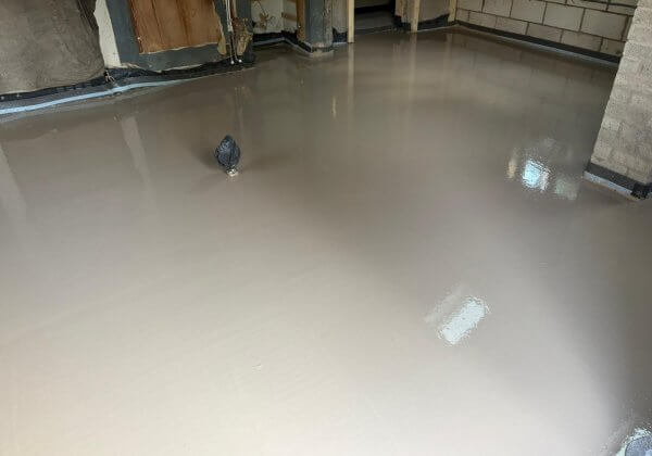 Completed Excelio liquid screed layer with a smooth, level surface ready for underfloor heating installation