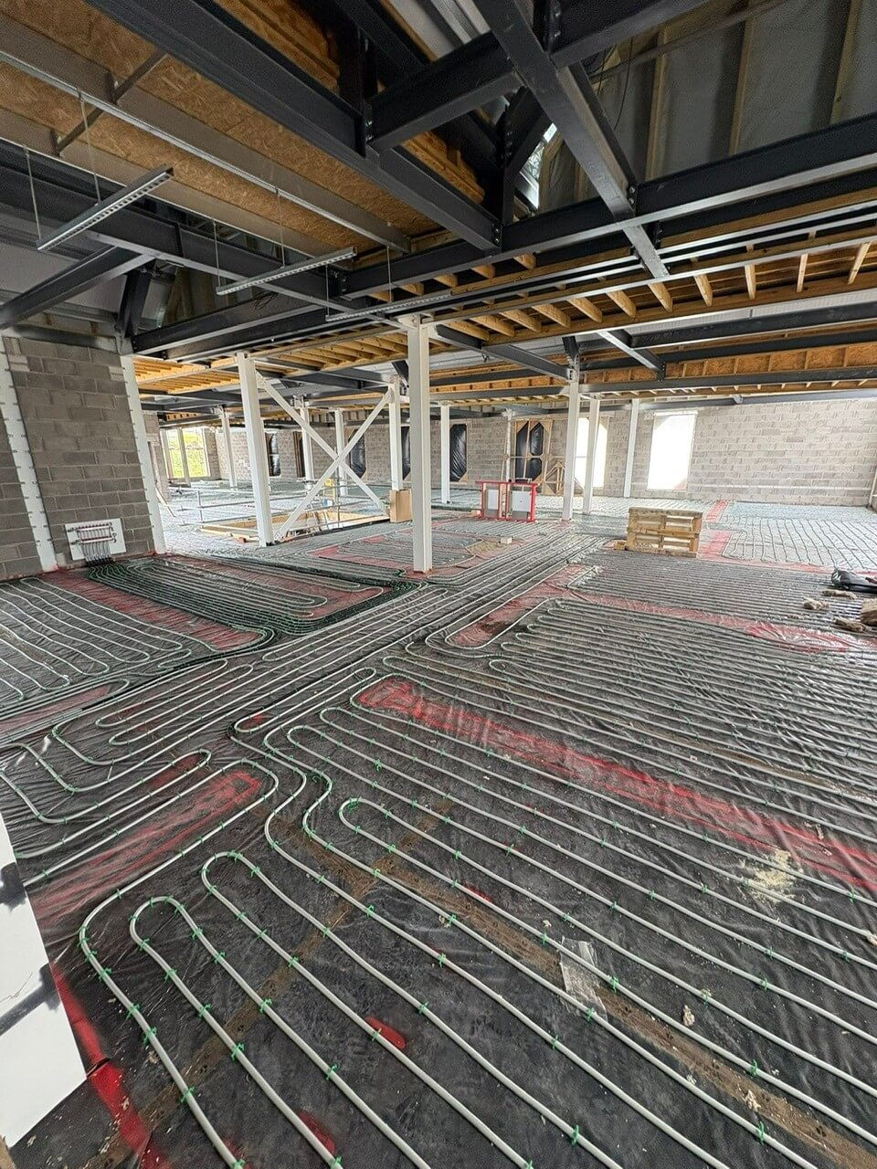 EasyFlow team installing underfloor heating pipes during Phase 2 of the Leominster Health Centre project