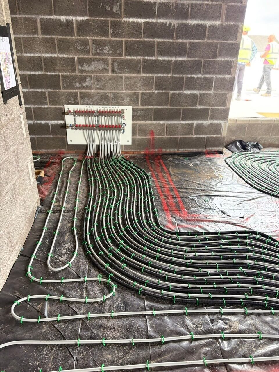 EasyFlow engineer carrying out a final quality inspection of the underfloor heating system installation