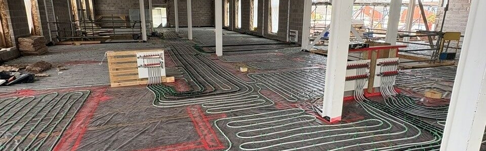 Close-up of underfloor heating pipework being laid evenly across the first floor of Leominster Health Centre