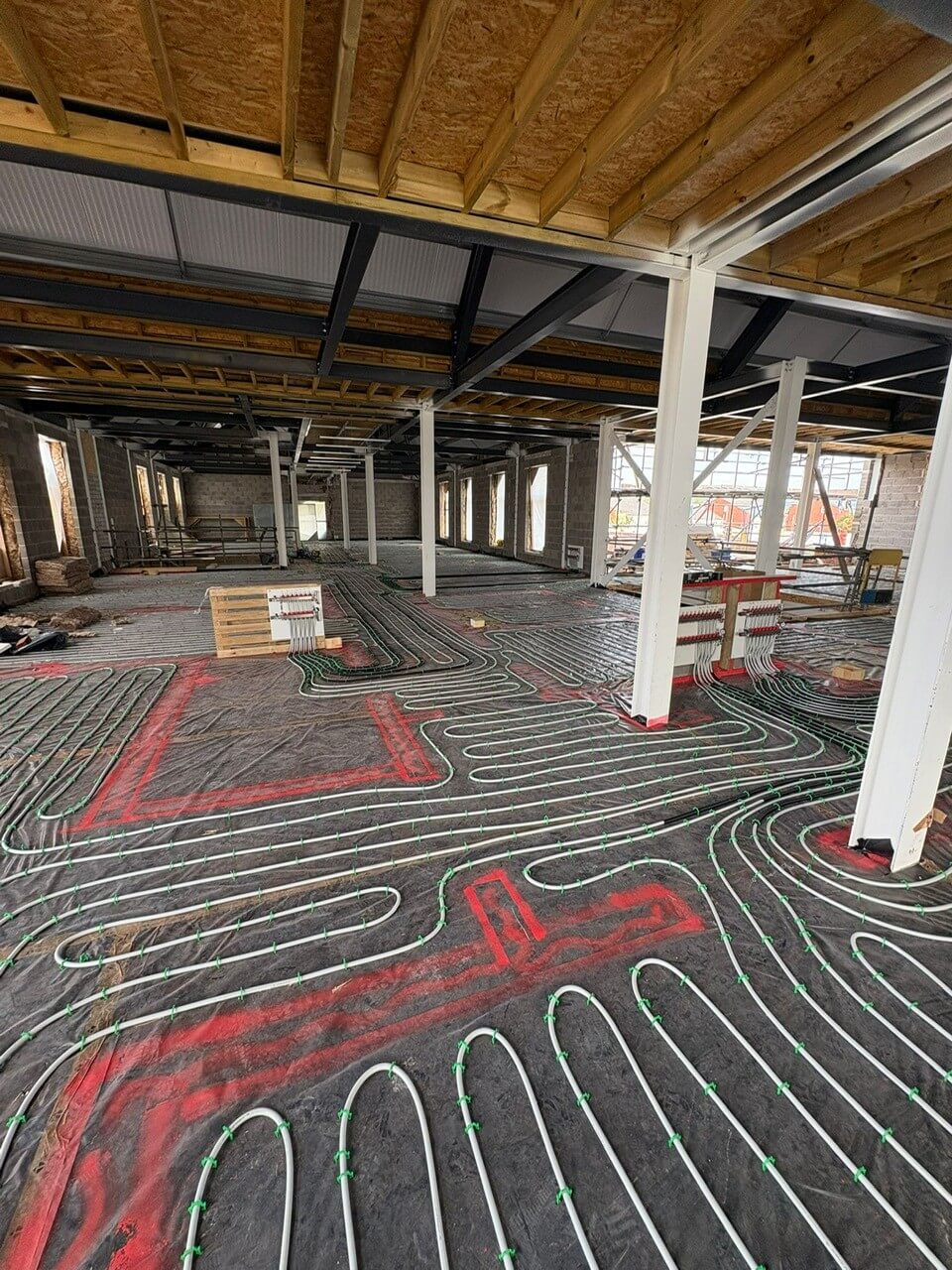 Close-up of underfloor heating pipework being laid evenly across the first floor of Leominster Health Centre
