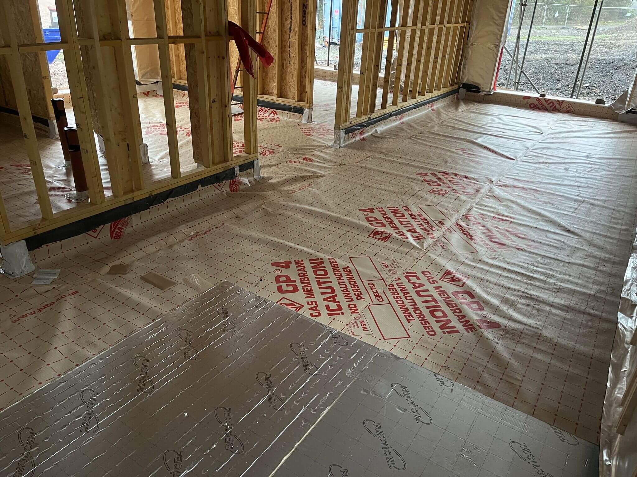 Floor preparation in a downstairs room by an underfloor heating installer