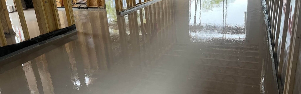 Liquid screed on the ground floor poured by an underfloor heating installer