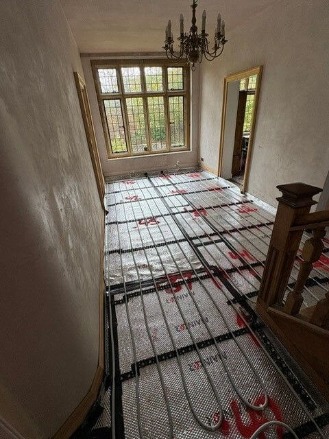 Underfloor heating for wooden flooring in property entrance