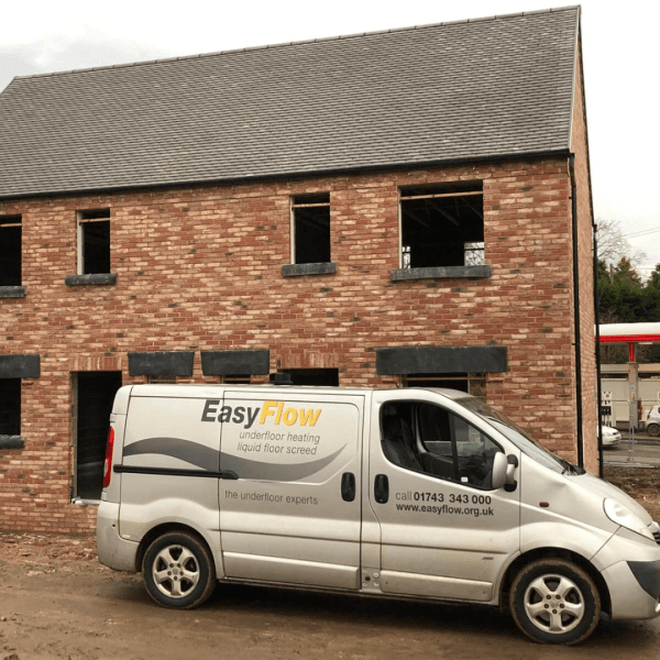 an easyflow truck parked outside a new build house