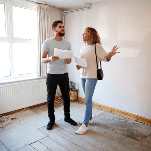 Two people reading the work plan for an underfloor heating retrofit