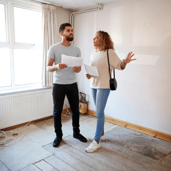Two people reading the work plan for an underfloor heating retrofit